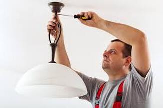 Electrician installing lighting
