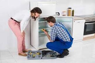 Electricians installing refrigerator